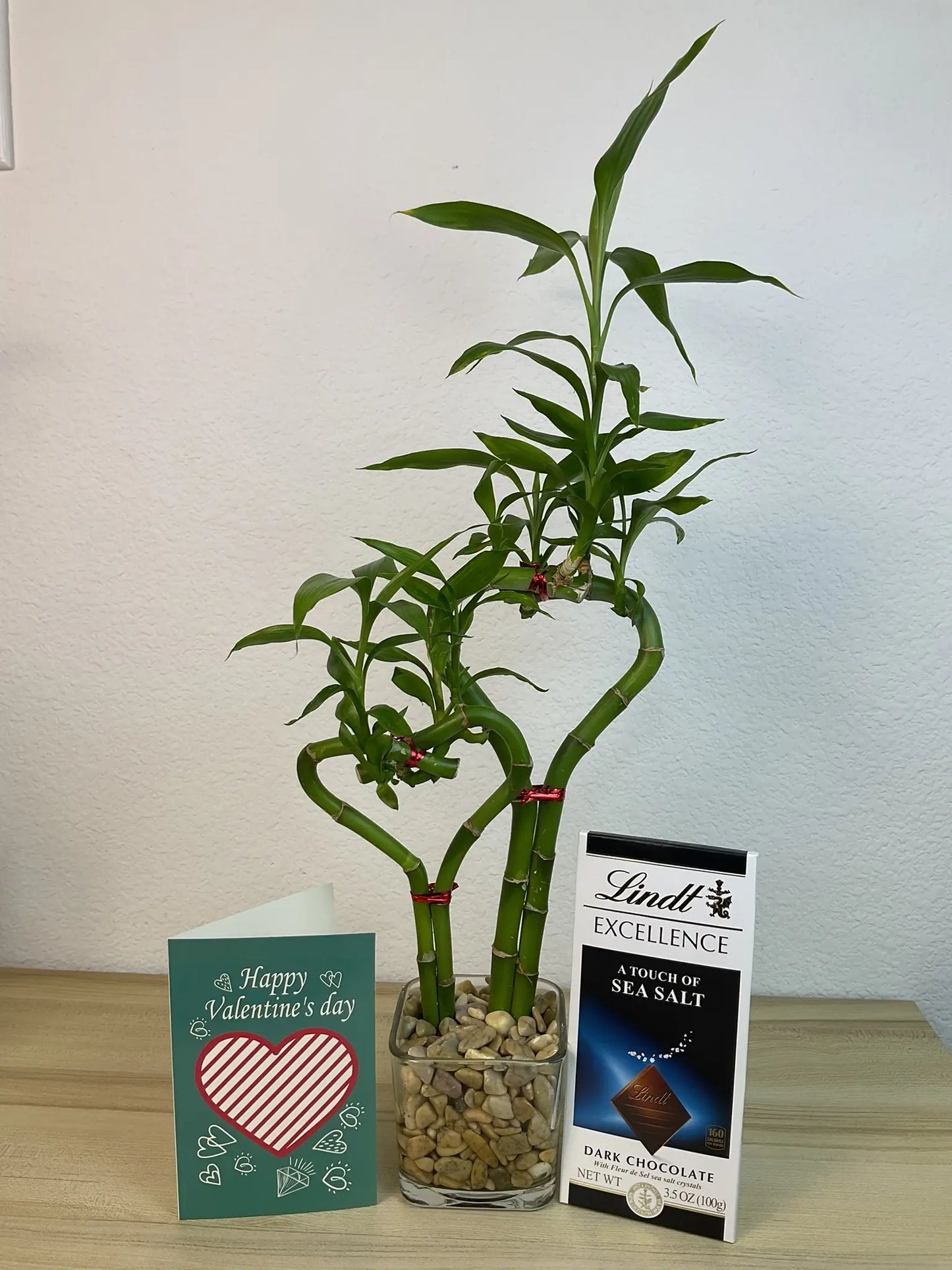 Double heart lucky bamboo with Valentine card and Lindt Sea salt Bar in 3.5 inch square vase 