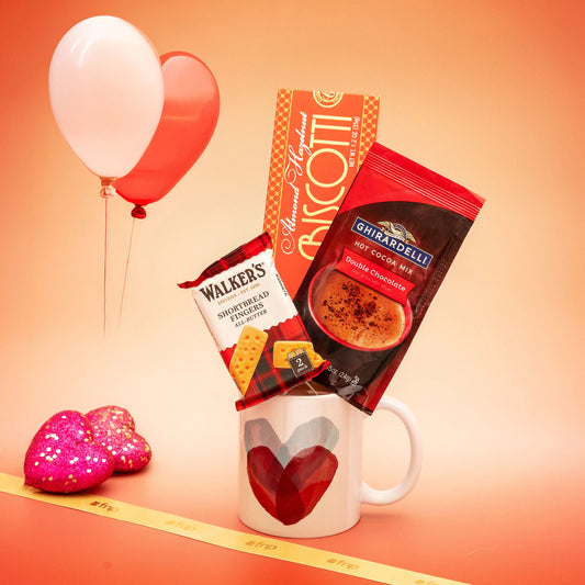 Romantic indulgence gift pack with heart-shaped mug, almond hazelnut biscotti, Walkers shortbread, and Ghirardelli cocoa